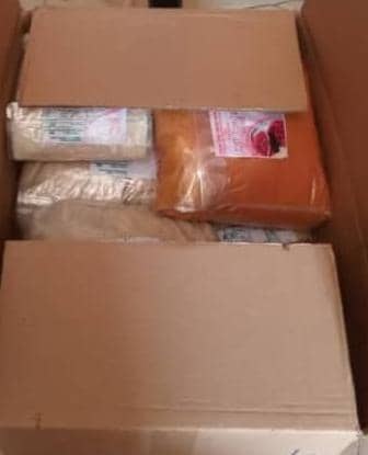 Carton packed with sealed food items ready to ship